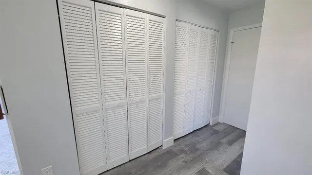 a view of walk in closet with empty racks