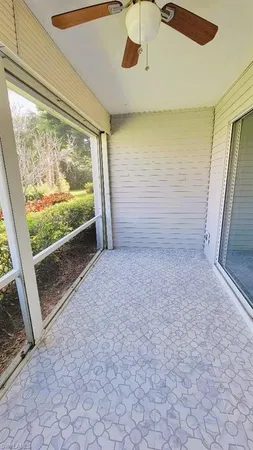 a view of a glass door and a yard from a balcony