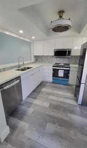 a kitchen with stainless steel appliances granite countertop a stove and a sink