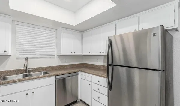a kitchen with appliances a sink and cabinets