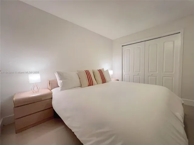 a large white bed in a white room