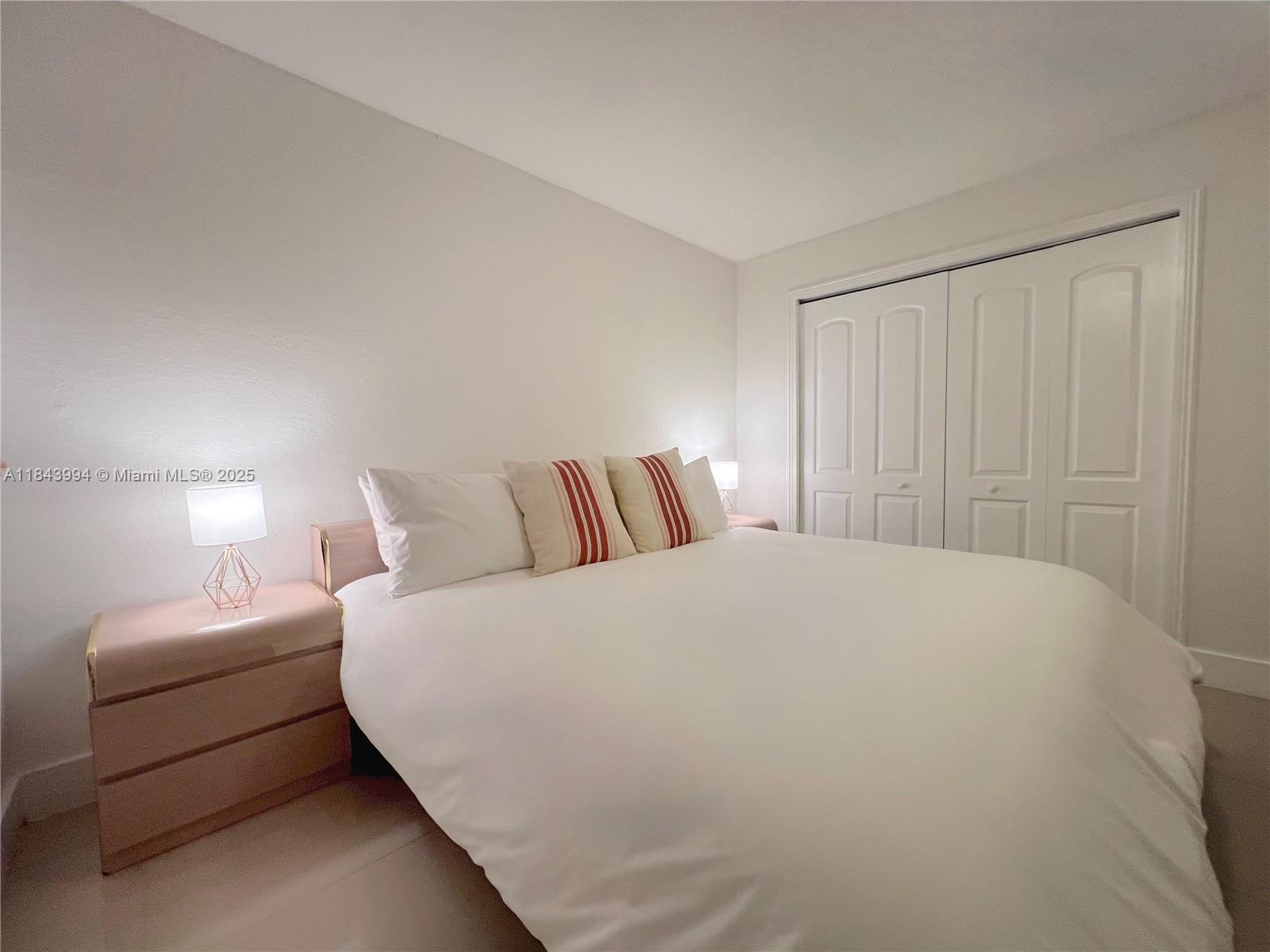 636 Northwest 11th Street, Unit 636 Miami, FL 33136 - Photo 13 of 17 a large white bed in a white room