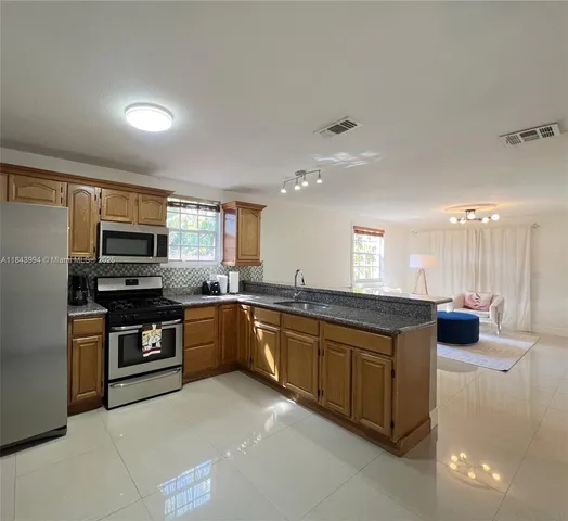 a large kitchen with stainless steel appliances
