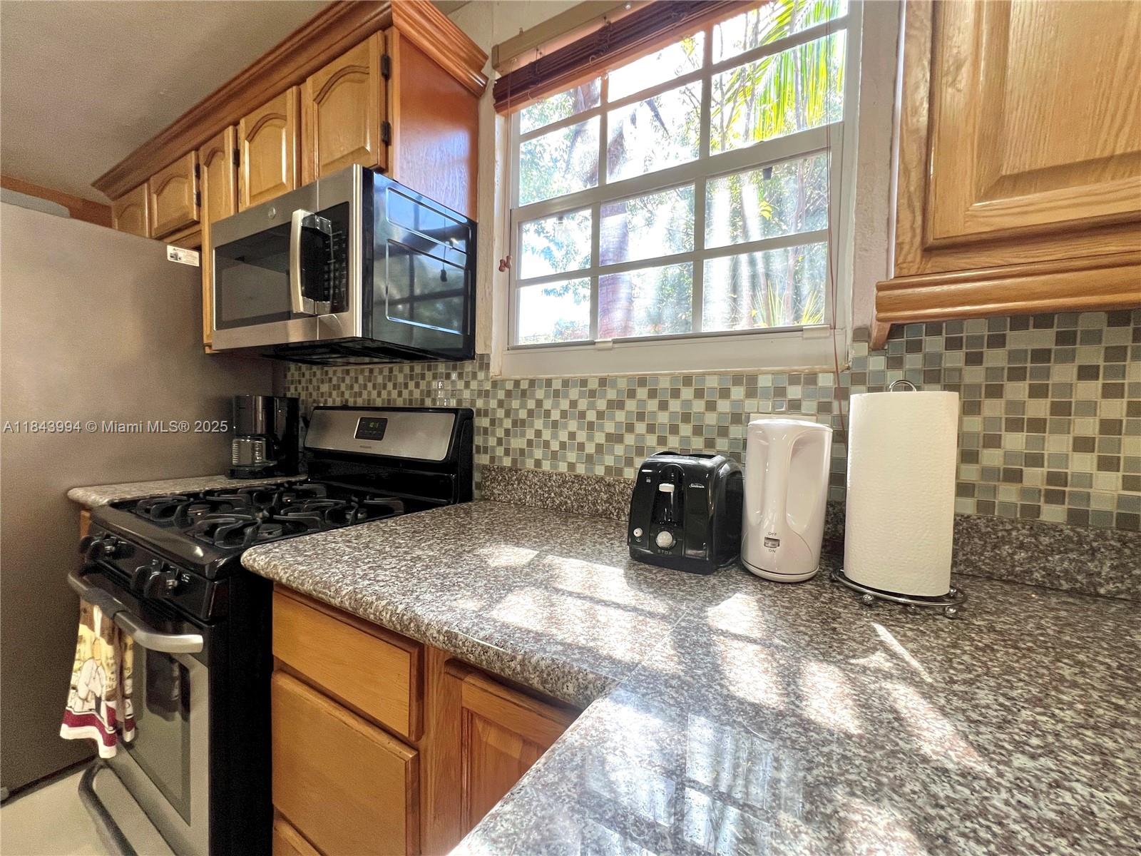 636 Northwest 11th Street, Unit 636 Miami, FL 33136 - Photo 5 of 17 a kitchen with a stove and a sink