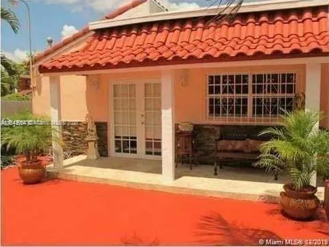 a balcony with a table and chairs