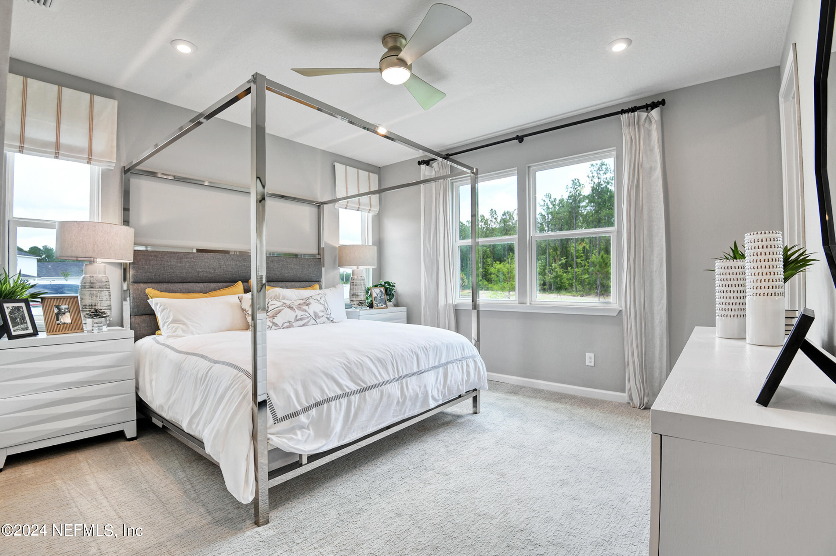 7213 Red Timber Road Jacksonville, FL 32244 - Photo 11 of 17 a bedroom with a large bed and a chandelier