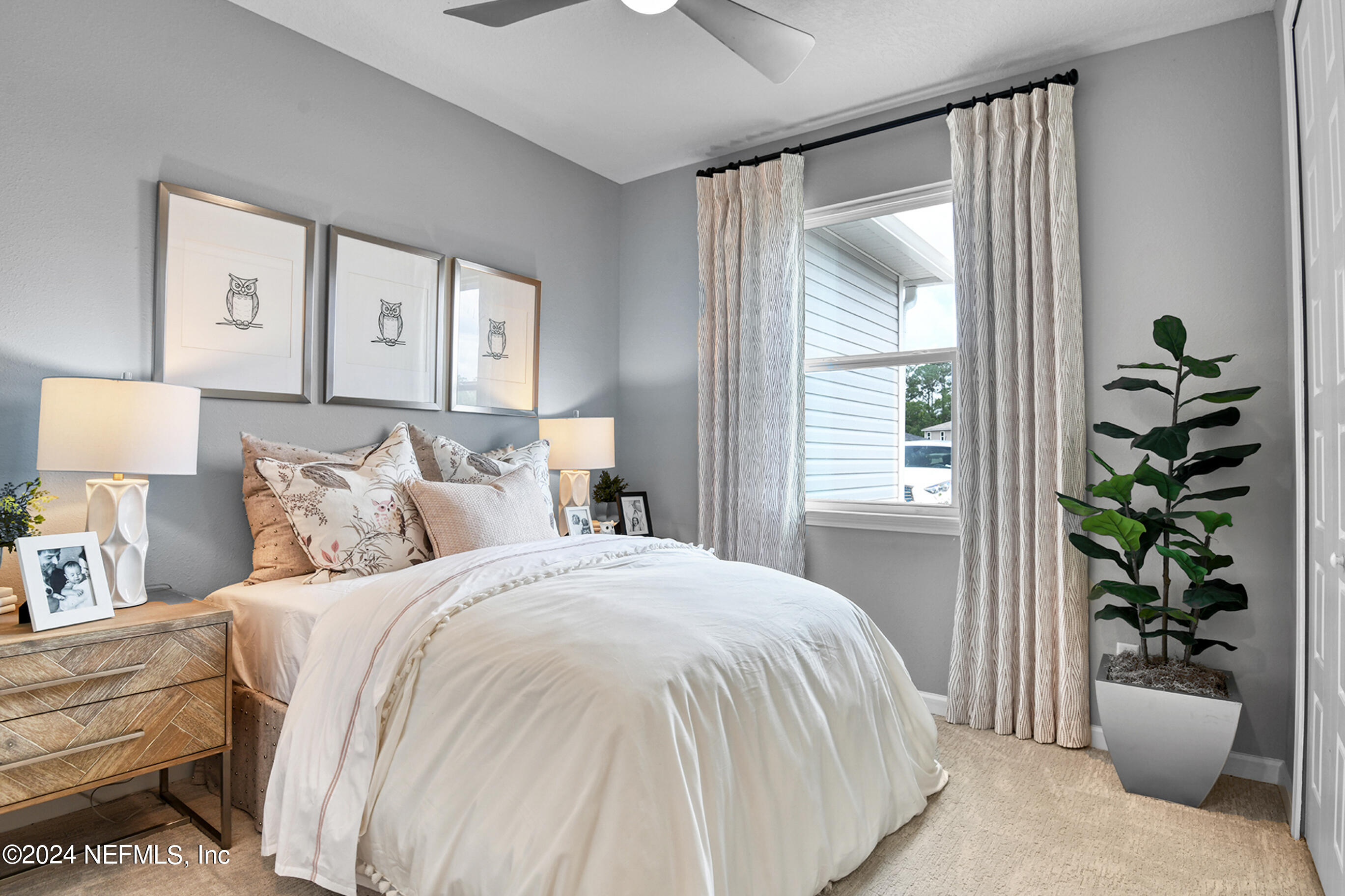 7213 Red Timber Road Jacksonville, FL 32244 - Photo 15 of 17 a bedroom with a balcony a bed and a potted plant