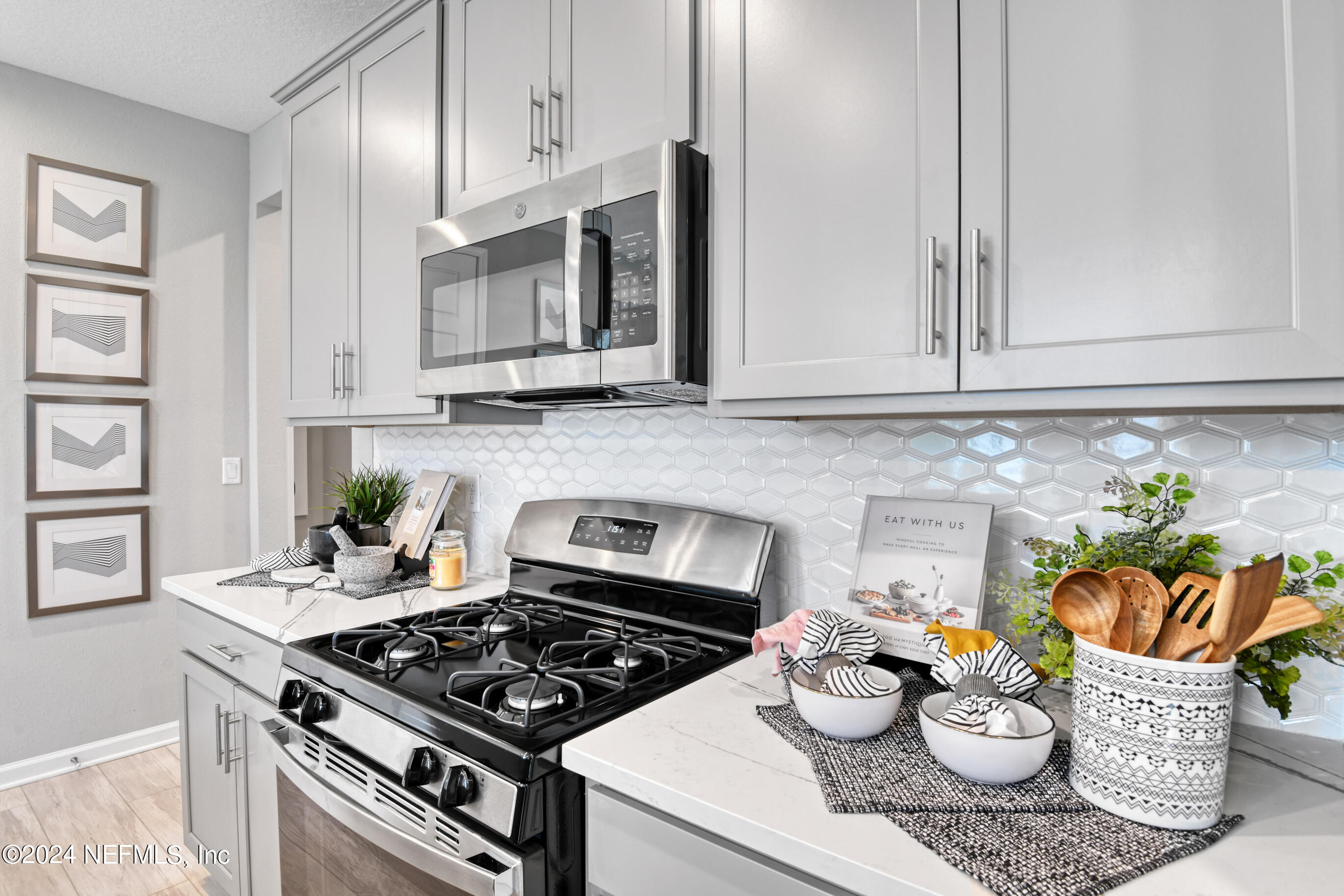 7213 Red Timber Road Jacksonville, FL 32244 - Photo 7 of 17 a kitchen with a stove and a white wooden cabinets