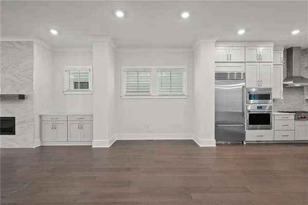 a kitchen with stainless steel appliances a stove a sink and a refrigerator