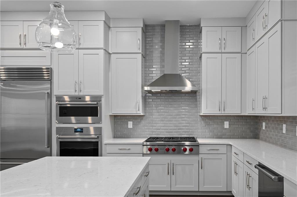 320 Anglin Walk Alpharetta, GA 30009 - Photo 14 of 67 a kitchen with stainless steel appliances a stove a sink and a refrigerator