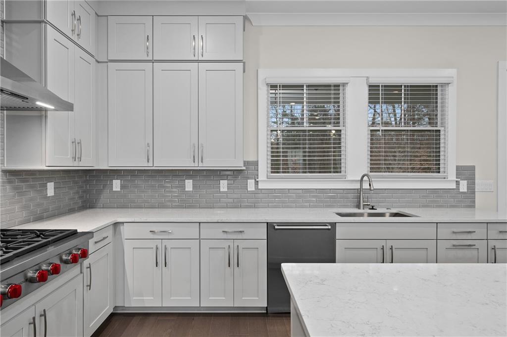 320 Anglin Walk Alpharetta, GA 30009 - Photo 15 of 67 a kitchen with stainless steel appliances granite countertop a sink stove and cabinets
