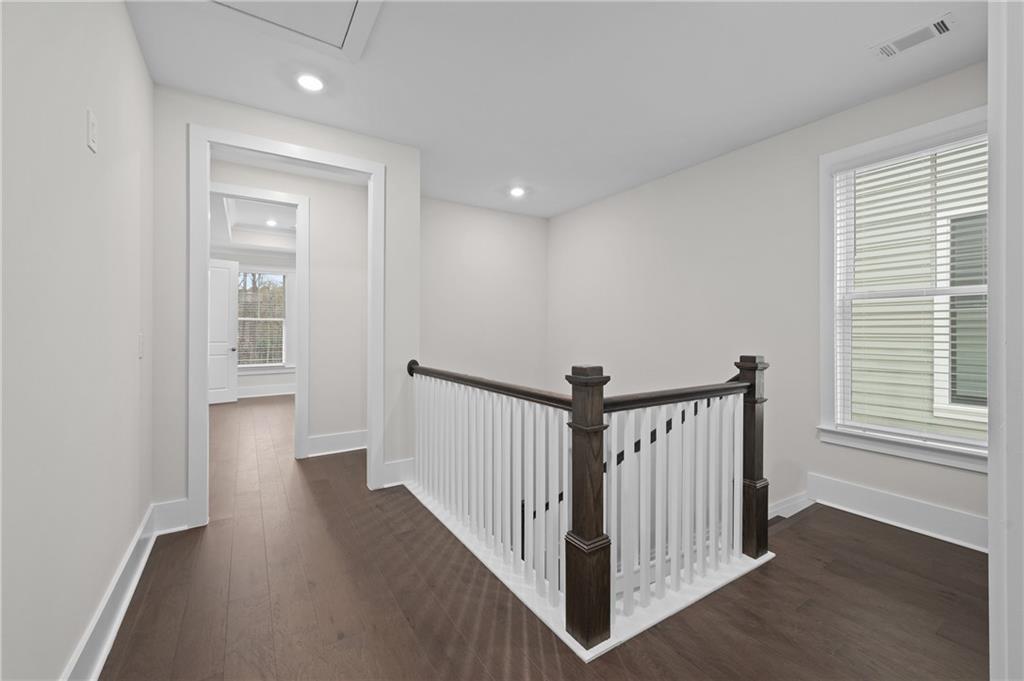 320 Anglin Walk Alpharetta, GA 30009 - Photo 19 of 67 a view of a hallway with a white walls and wooden floor