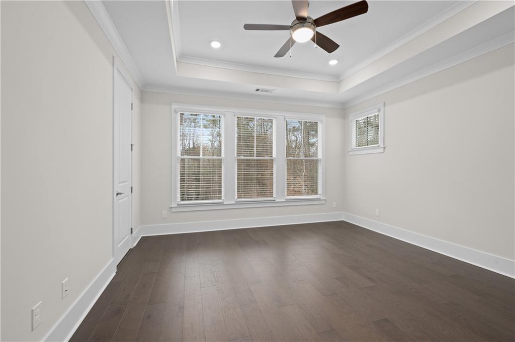 320 Anglin Walk Alpharetta, GA 30009 - Photo 20 of 67 an empty room with wooden floor fan and windows