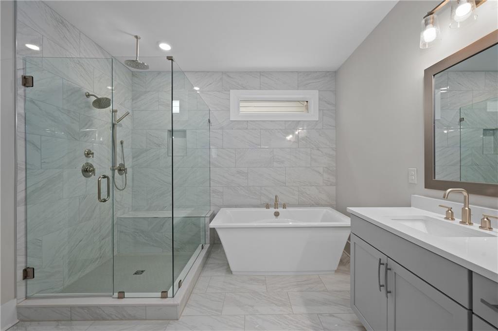 320 Anglin Walk Alpharetta, GA 30009 - Photo 23 of 67 a bathroom with a white tub shower vanity and a sink