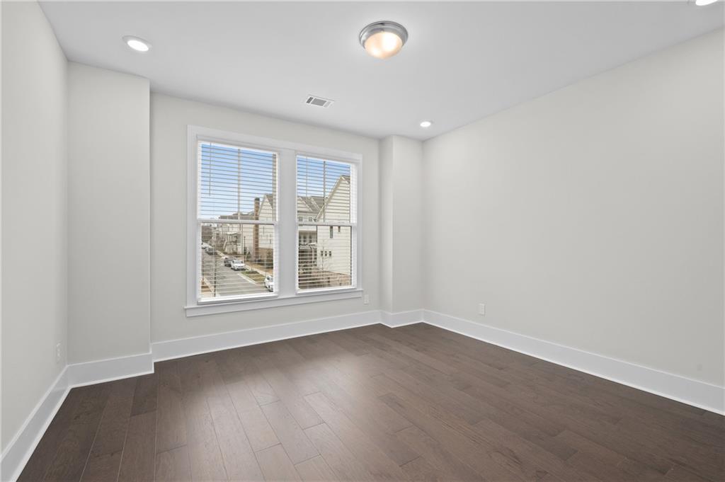320 Anglin Walk Alpharetta, GA 30009 - Photo 29 of 67 an empty room with wooden floor and windows
