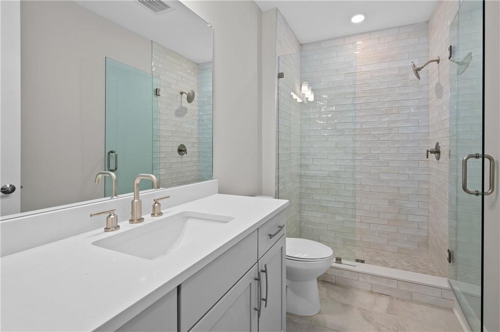 320 Anglin Walk Alpharetta, GA 30009 - Photo 36 of 67 a bathroom with a sink a toilet and shower