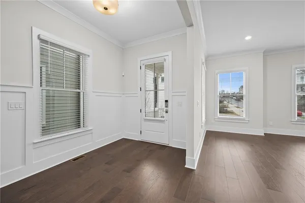 a view of an empty room with a fireplace and a window