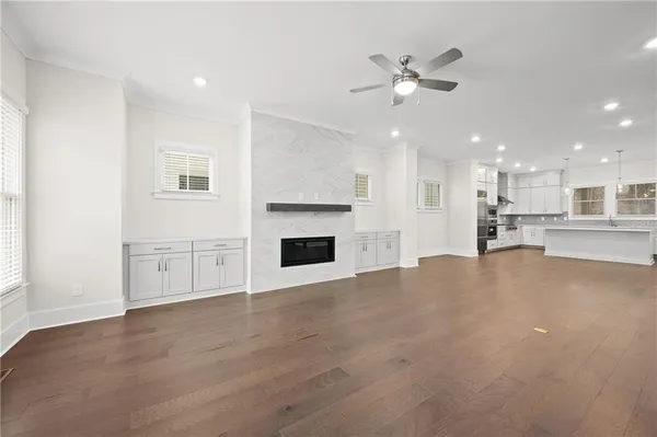 a view of empty room with wooden floor and fireplace