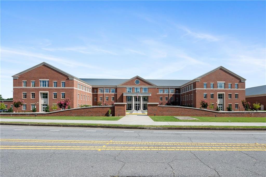 320 Anglin Walk Alpharetta, GA 30009 - Photo 67 of 67 a front view of residential houses with yard and trees in the background