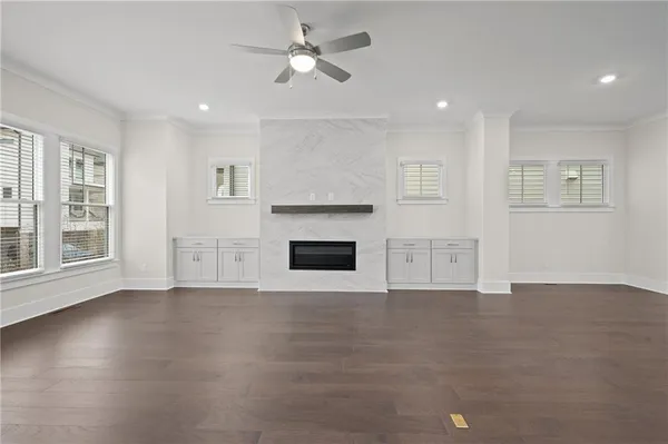 a large white kitchen with kitchen island a sink a stove and a refrigerator