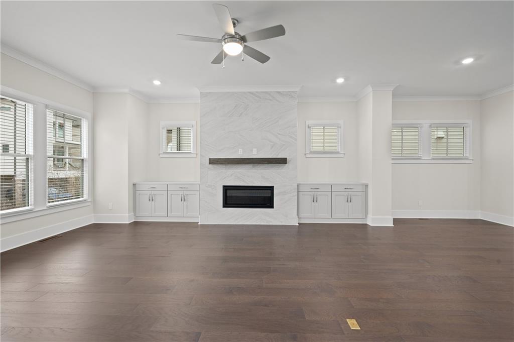 320 Anglin Walk Alpharetta, GA 30009 - Photo 8 of 67 a view of empty room with wooden floor and fireplace