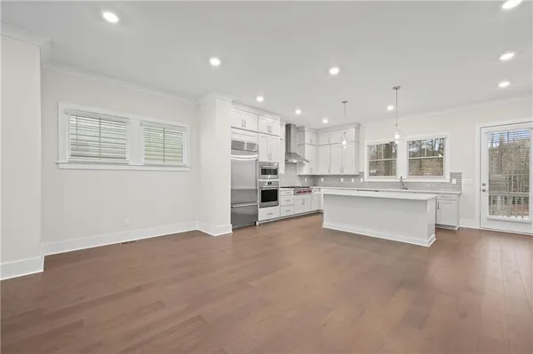 a kitchen with a sink stainless steel appliances and cabinets
