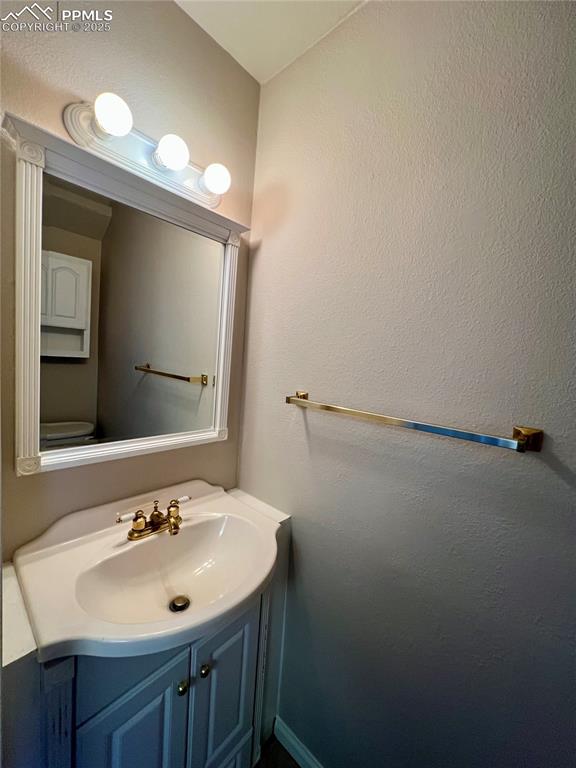 3150 Van Teylingen Drive, Unit E Colorado Springs, CO 80917 - Photo 11 of 24 a bathroom with a sink and a mirror