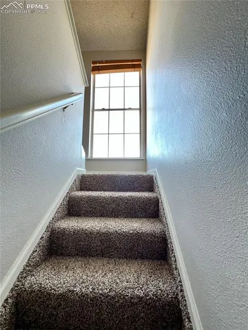 a bedroom with bed and a window