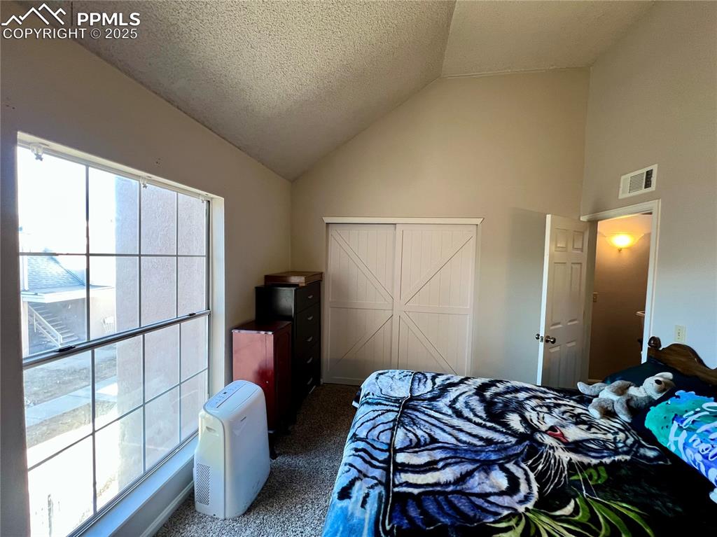 3150 Van Teylingen Drive, Unit E Colorado Springs, CO 80917 - Photo 15 of 24 a bedroom with a bed and a window