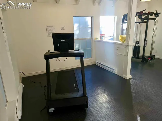 a living room with a table chairs and a flat screen tv