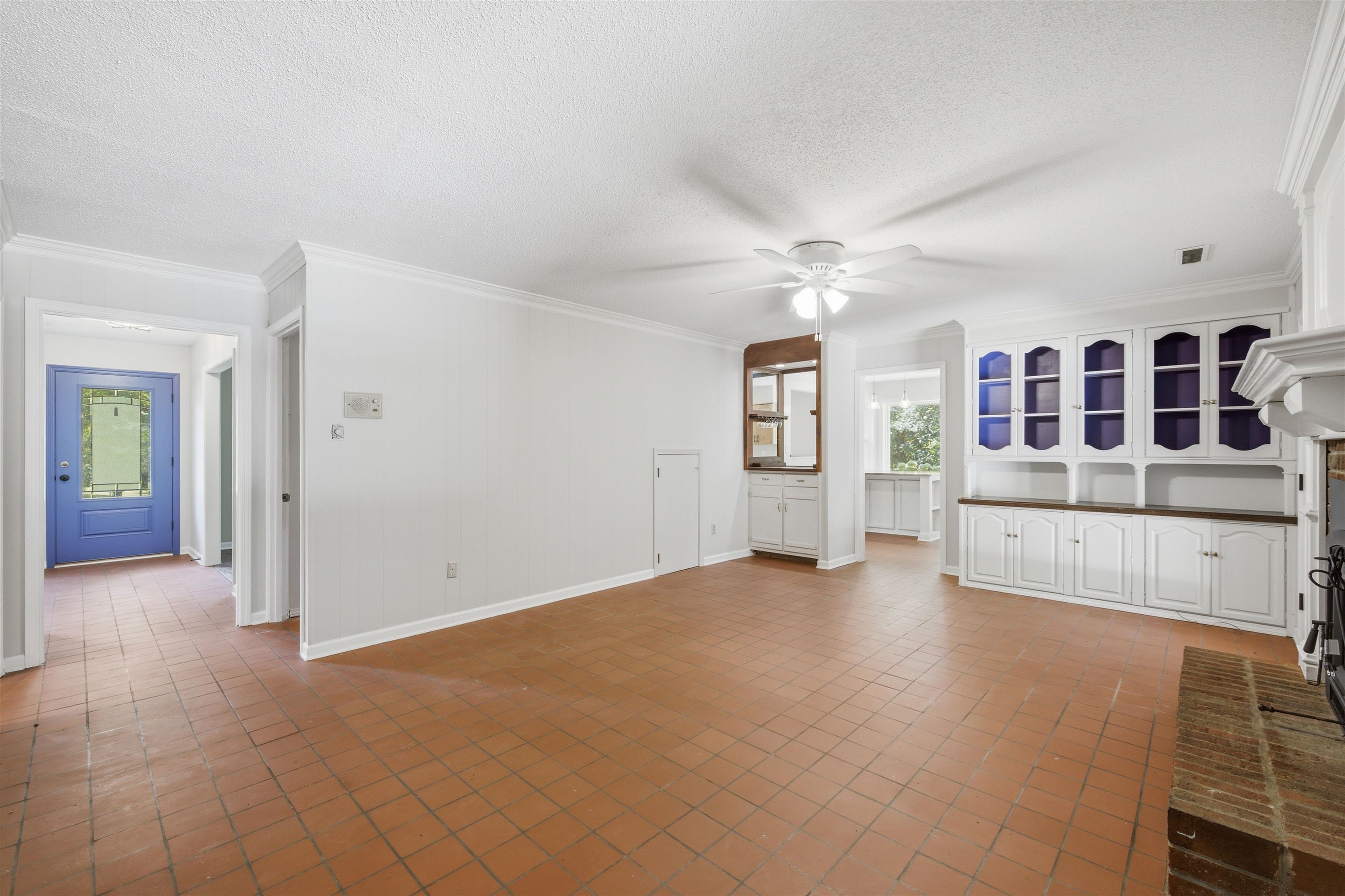 1370 North Reid Hooker Road Eads, TN 38028 - Photo 27 of 39 Spacious living area featuring tile flooring, built-in cabinetry, a ceiling fan, and a brick fireplace