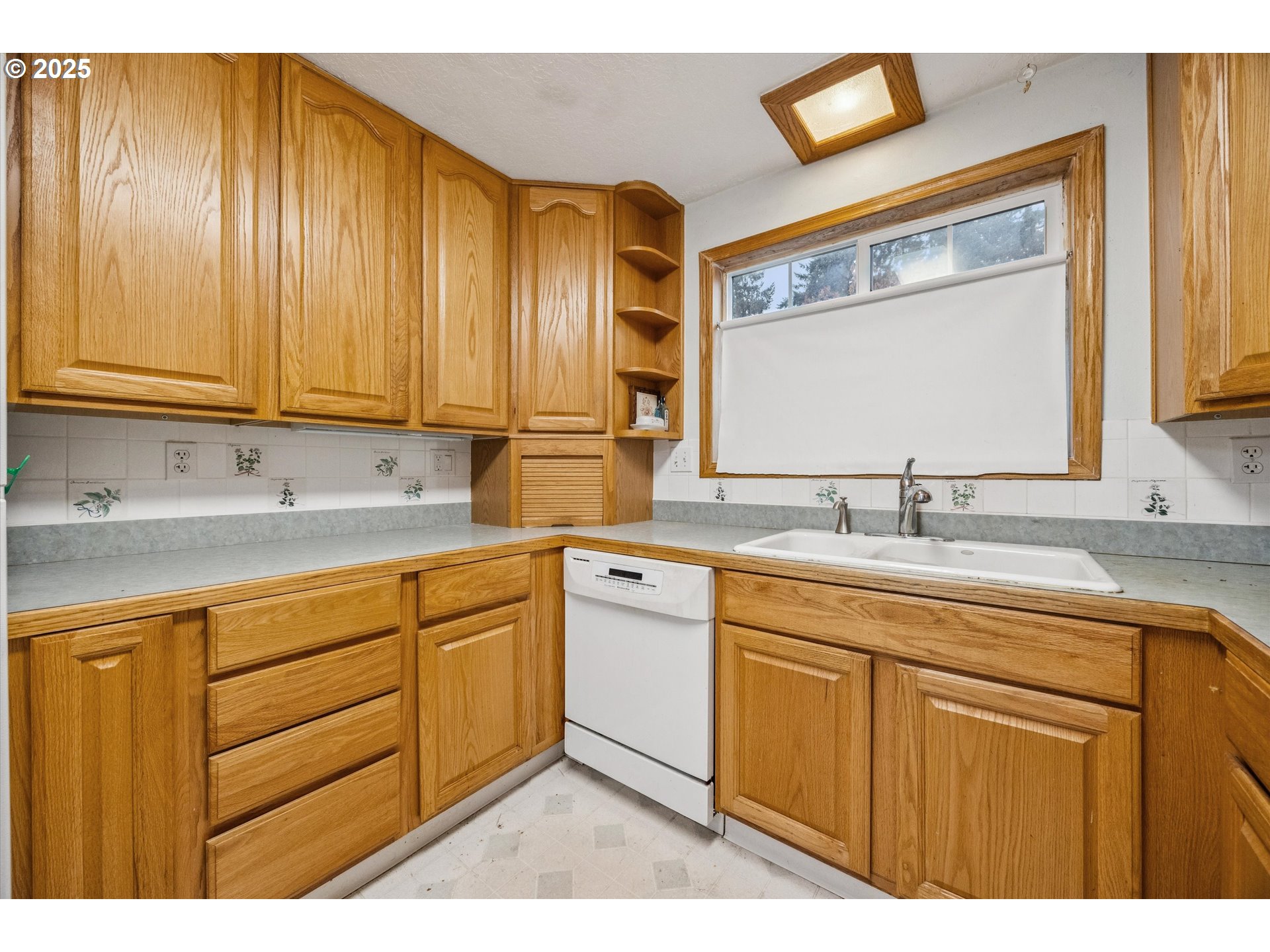 825 Northeast 194th Avenue Portland, OR 97230 - Photo 11 of 27 a kitchen with stainless steel appliances granite countertop a sink and cabinets with wooden floor