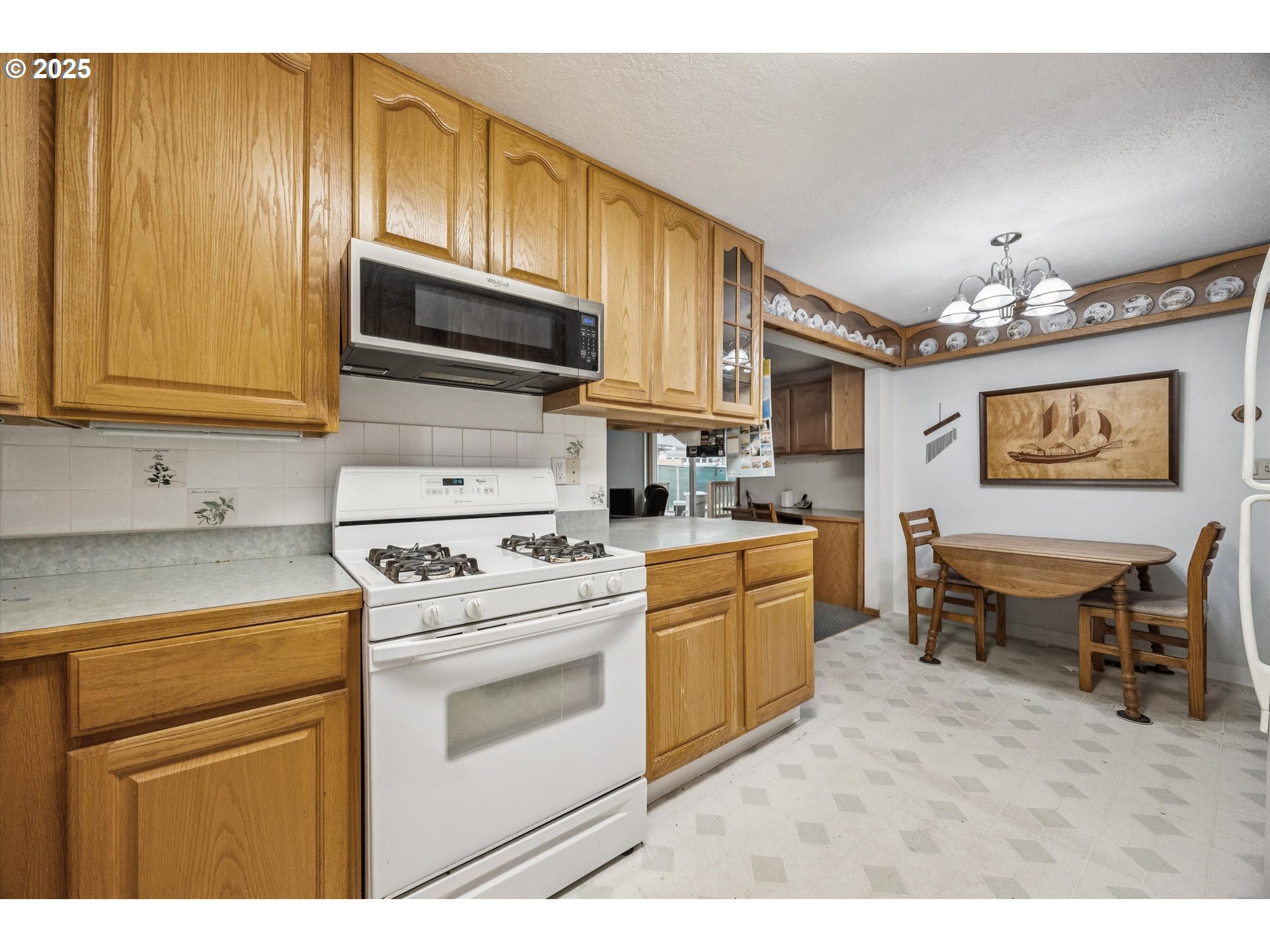 825 Northeast 194th Avenue Portland, OR 97230 - Photo 12 of 27 a kitchen with stainless steel appliances granite countertop a stove a sink dishwasher and a microwave oven with white cabinets