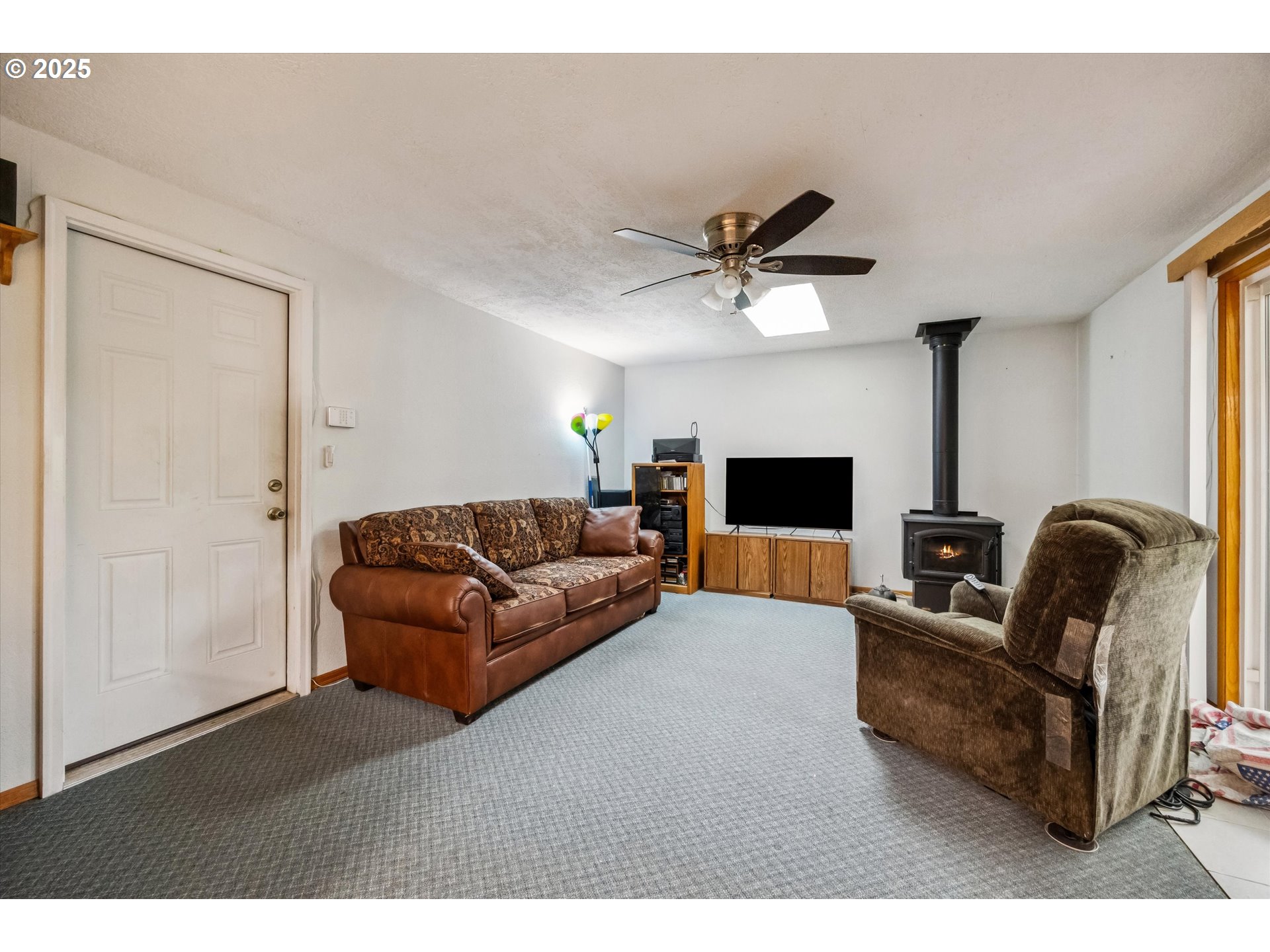 825 Northeast 194th Avenue Portland, OR 97230 - Photo 13 of 27 a living room with furniture and a flat screen tv