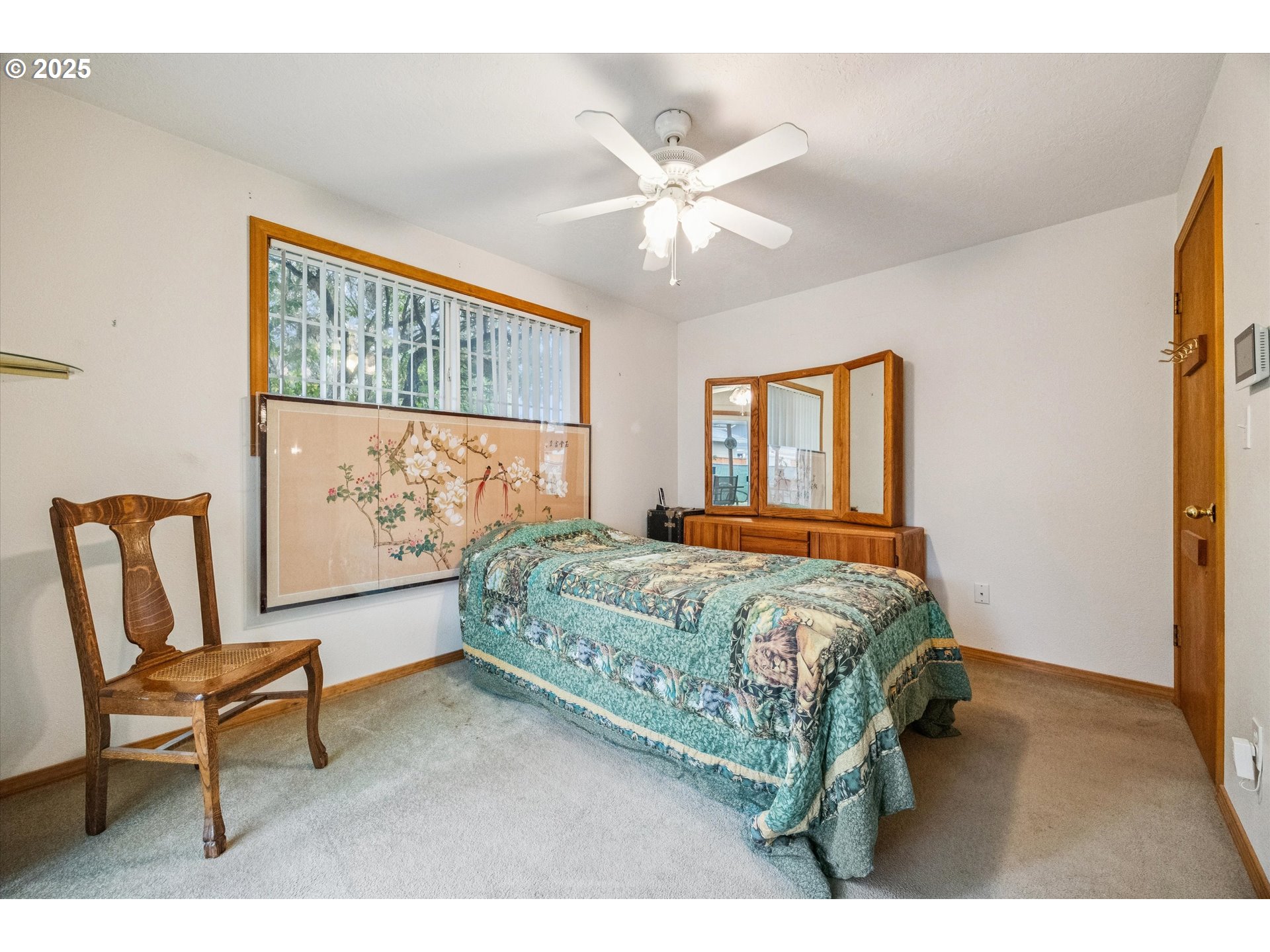 825 Northeast 194th Avenue Portland, OR 97230 - Photo 18 of 27 a bedroom with a bed chair and window