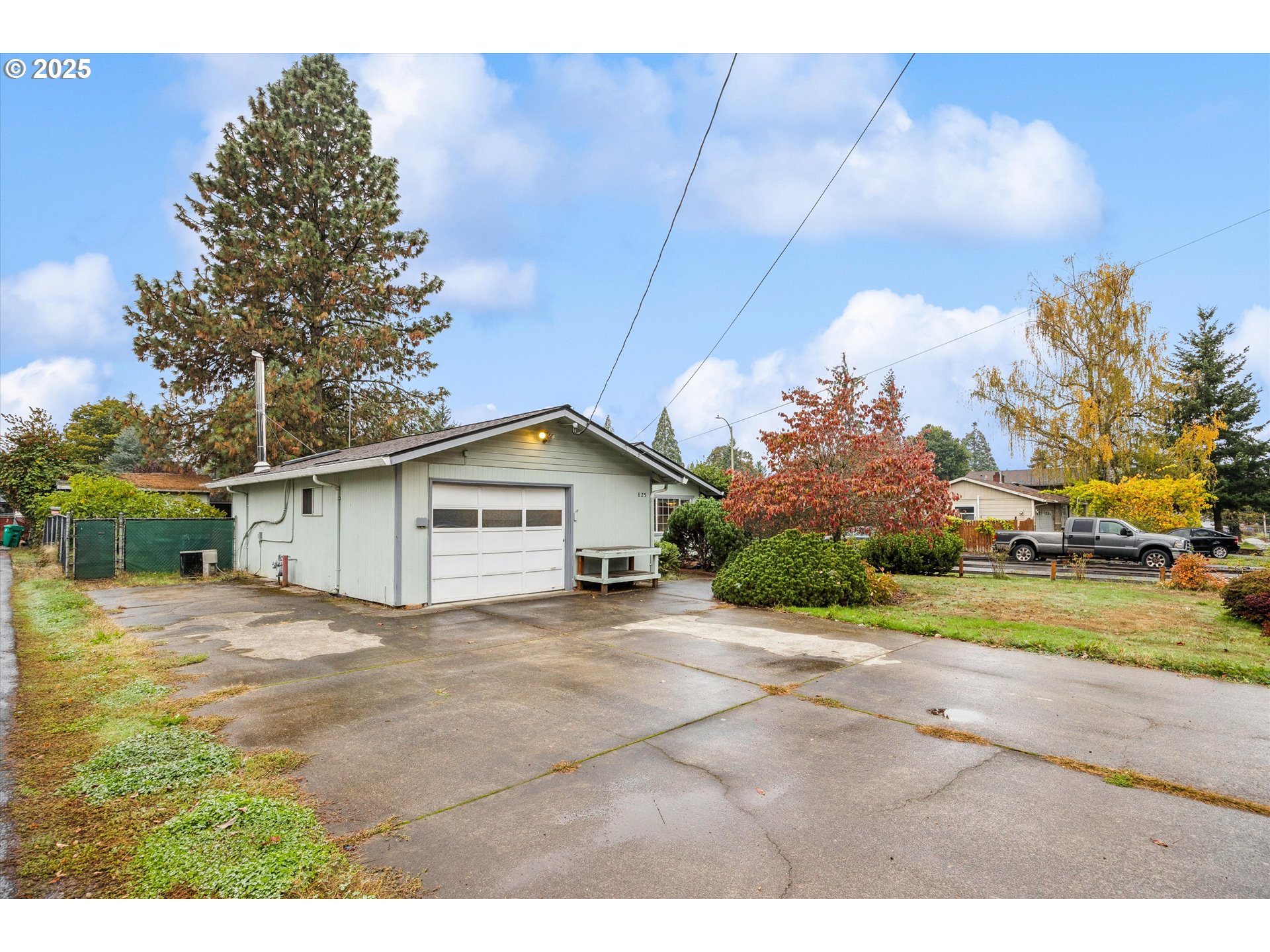 825 Northeast 194th Avenue Portland, OR 97230 - Photo 2 of 27 a view of a house with a yard and garage