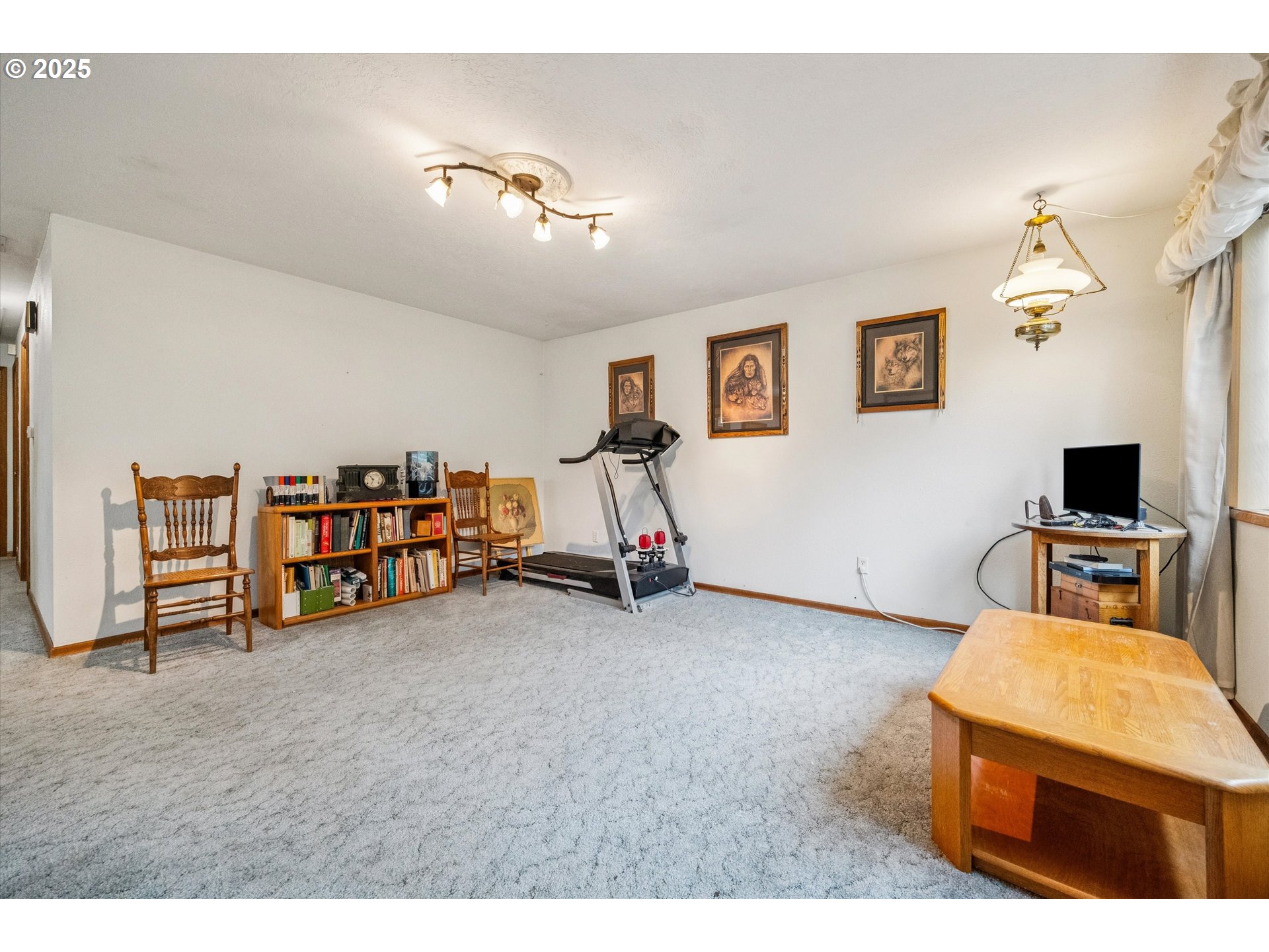 825 Northeast 194th Avenue Portland, OR 97230 - Photo 5 of 27 a living room with furniture and a flat screen tv