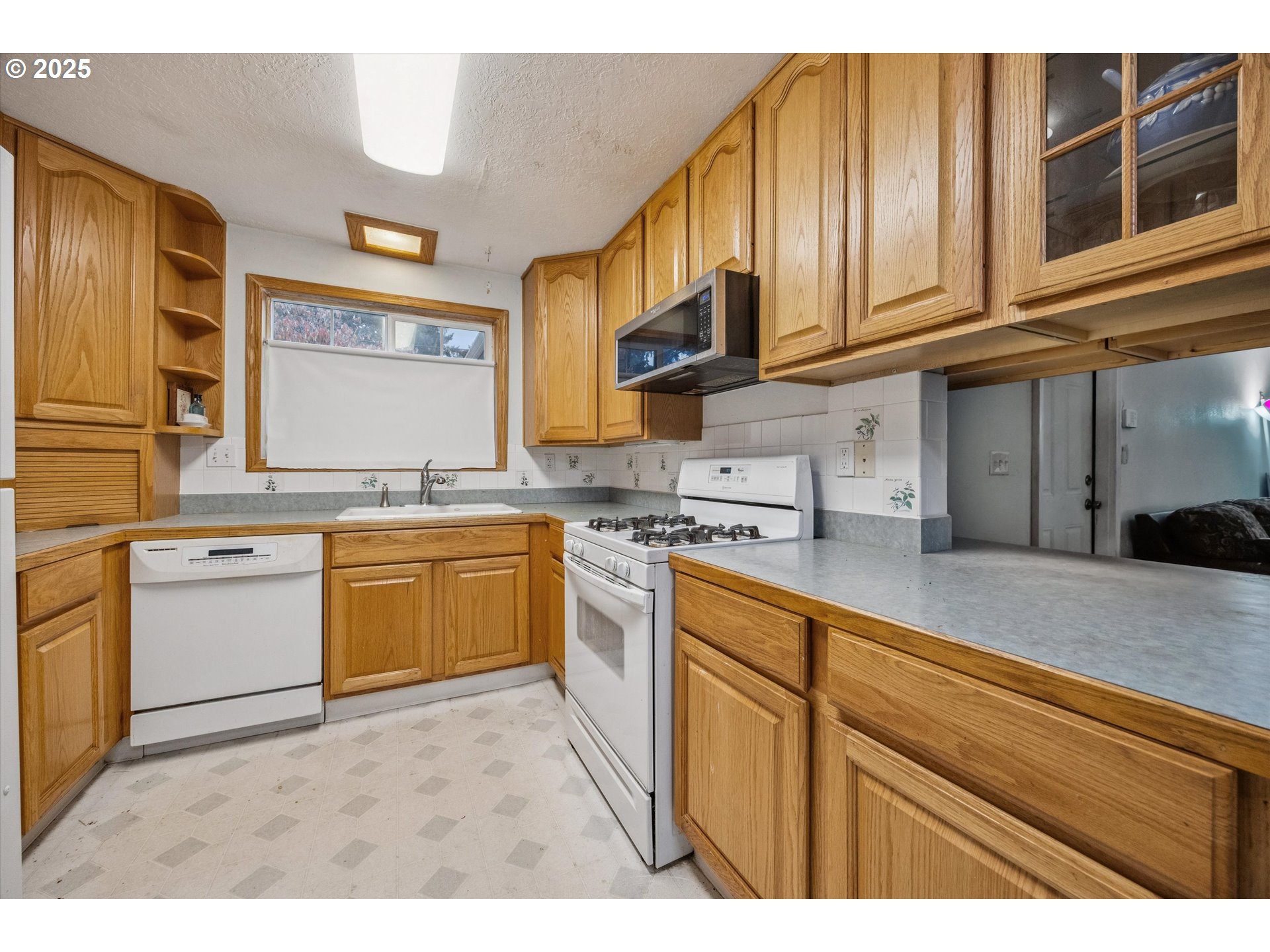825 Northeast 194th Avenue Portland, OR 97230 - Photo 9 of 27 a kitchen with stainless steel appliances granite countertop a sink and cabinets