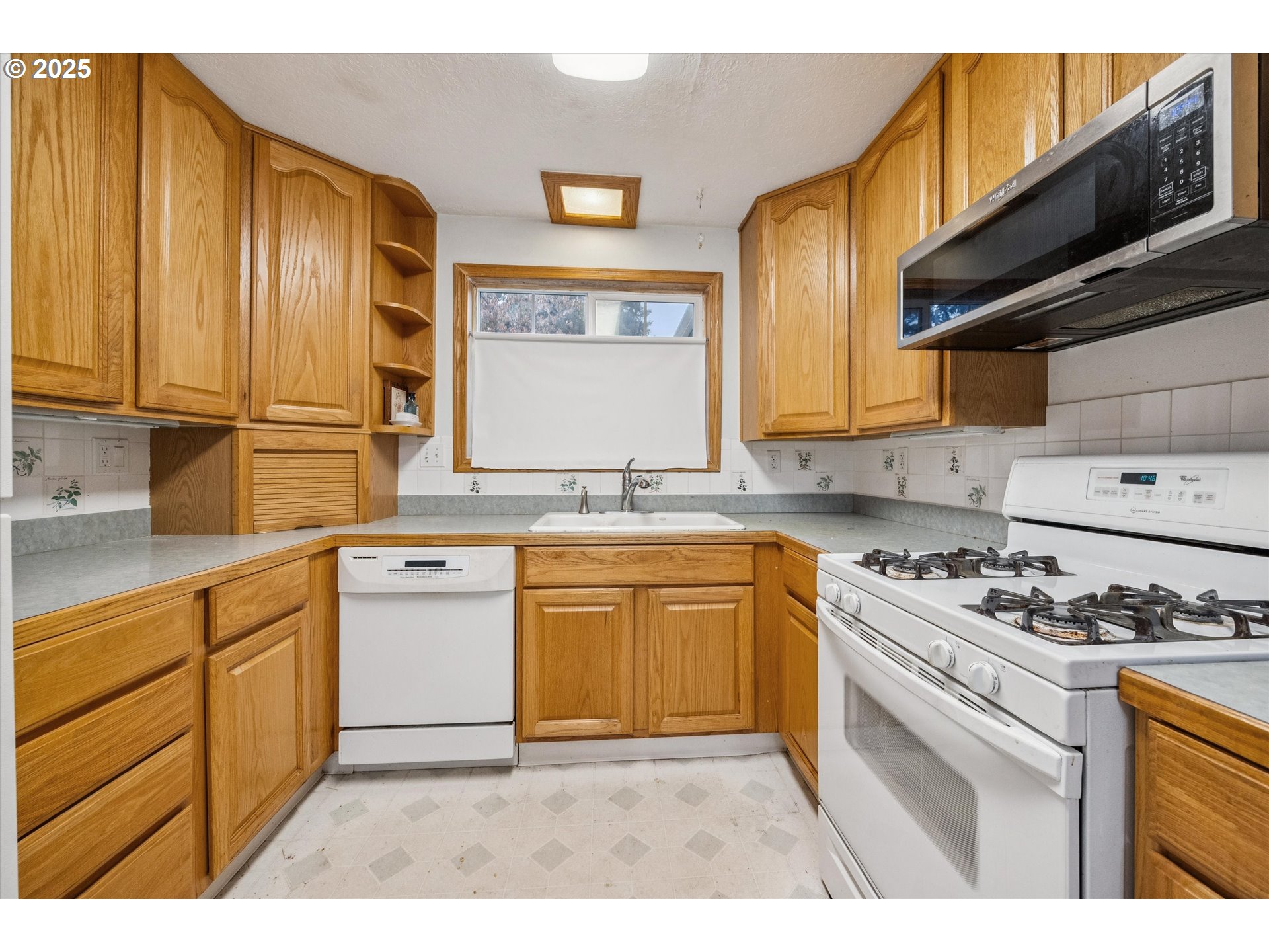 825 Northeast 194th Avenue Portland, OR 97230 - Photo 10 of 27 a kitchen with granite countertop cabinets stainless steel appliances a sink and a window