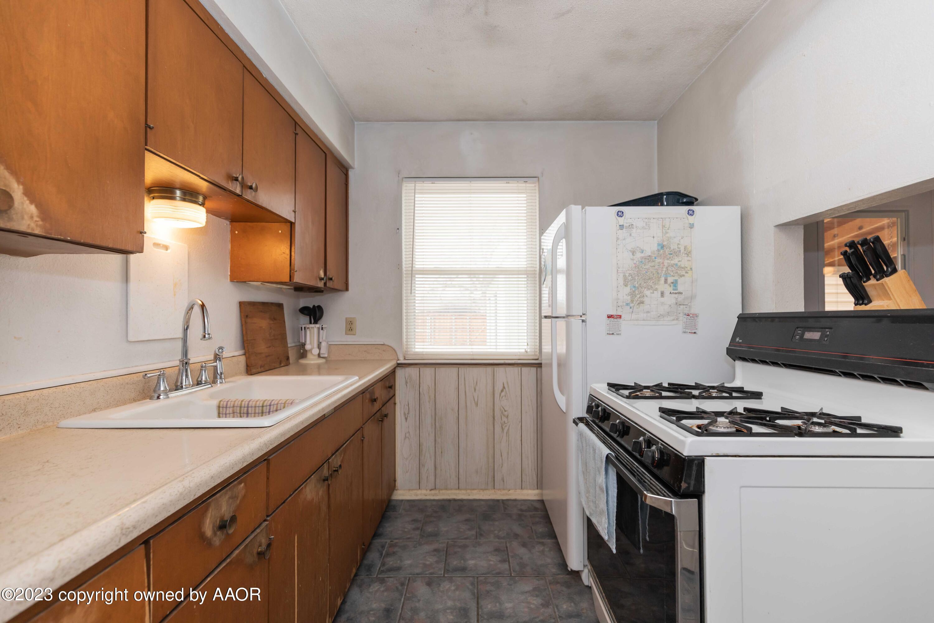 2920 South Nelson Street Amarillo, TX 79103 - Photo 13 of 47 a kitchen with stainless steel appliances a stove a sink and a refrigerator