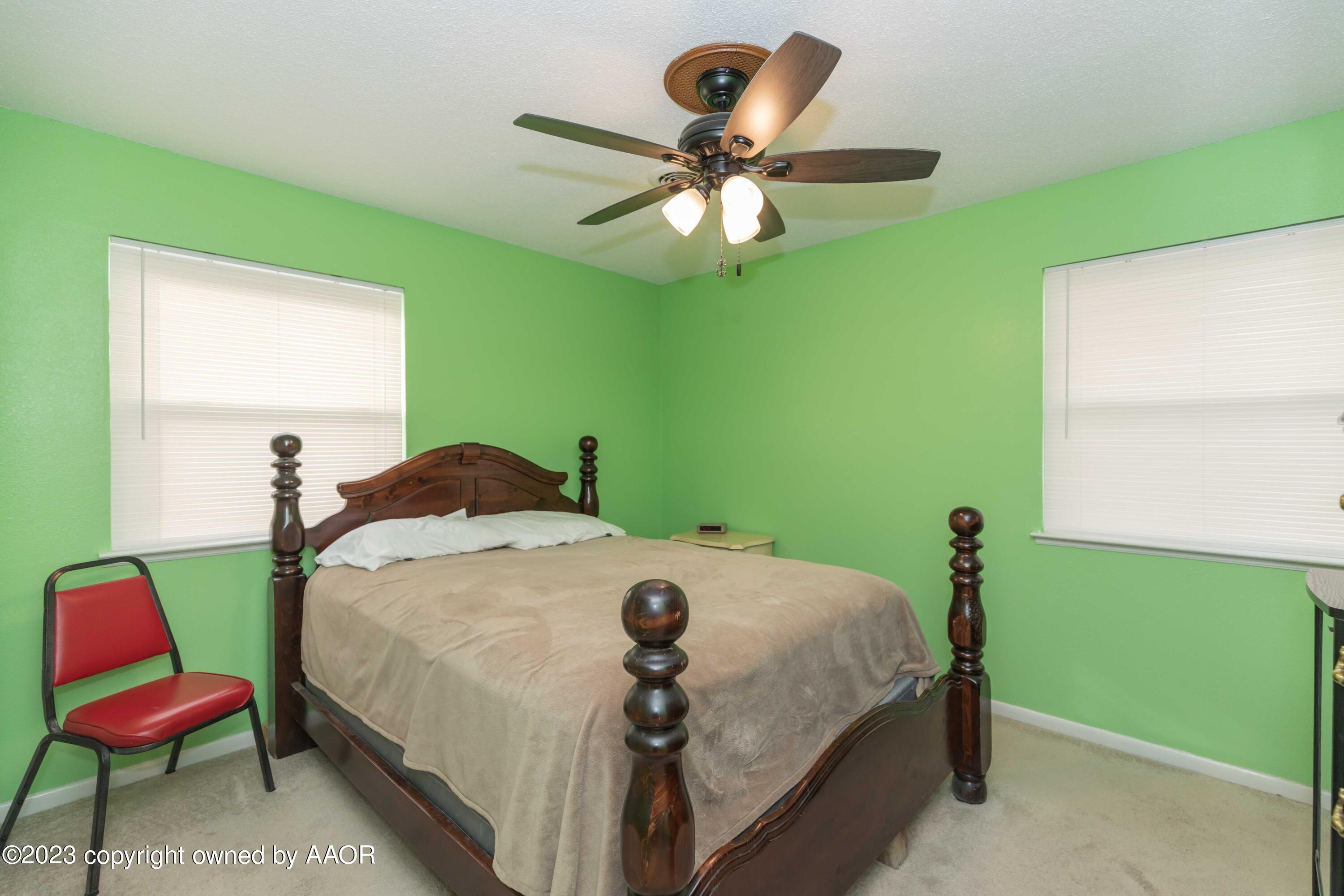 2920 South Nelson Street Amarillo, TX 79103 - Photo 17 of 47 a bedroom with a bed and a chair