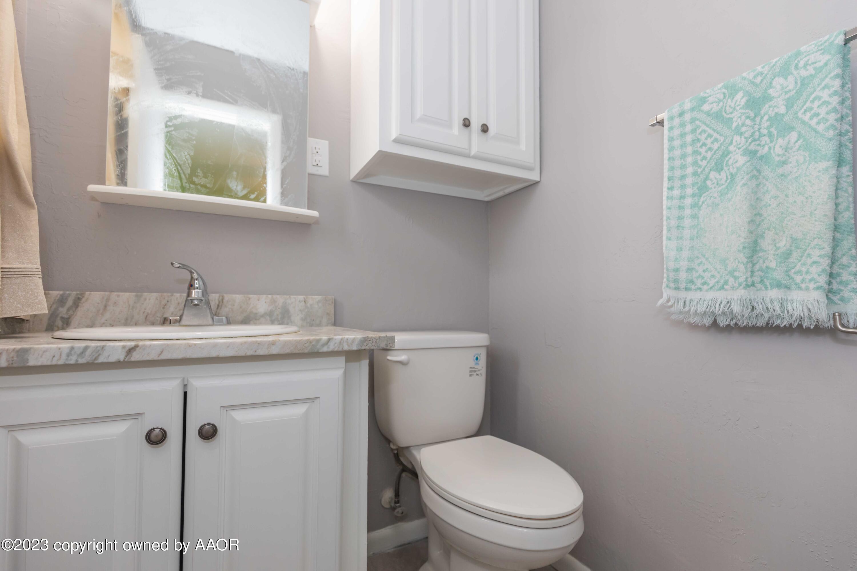 2920 South Nelson Street Amarillo, TX 79103 - Photo 21 of 47 a bathroom with a granite countertop toilet sink and mirror