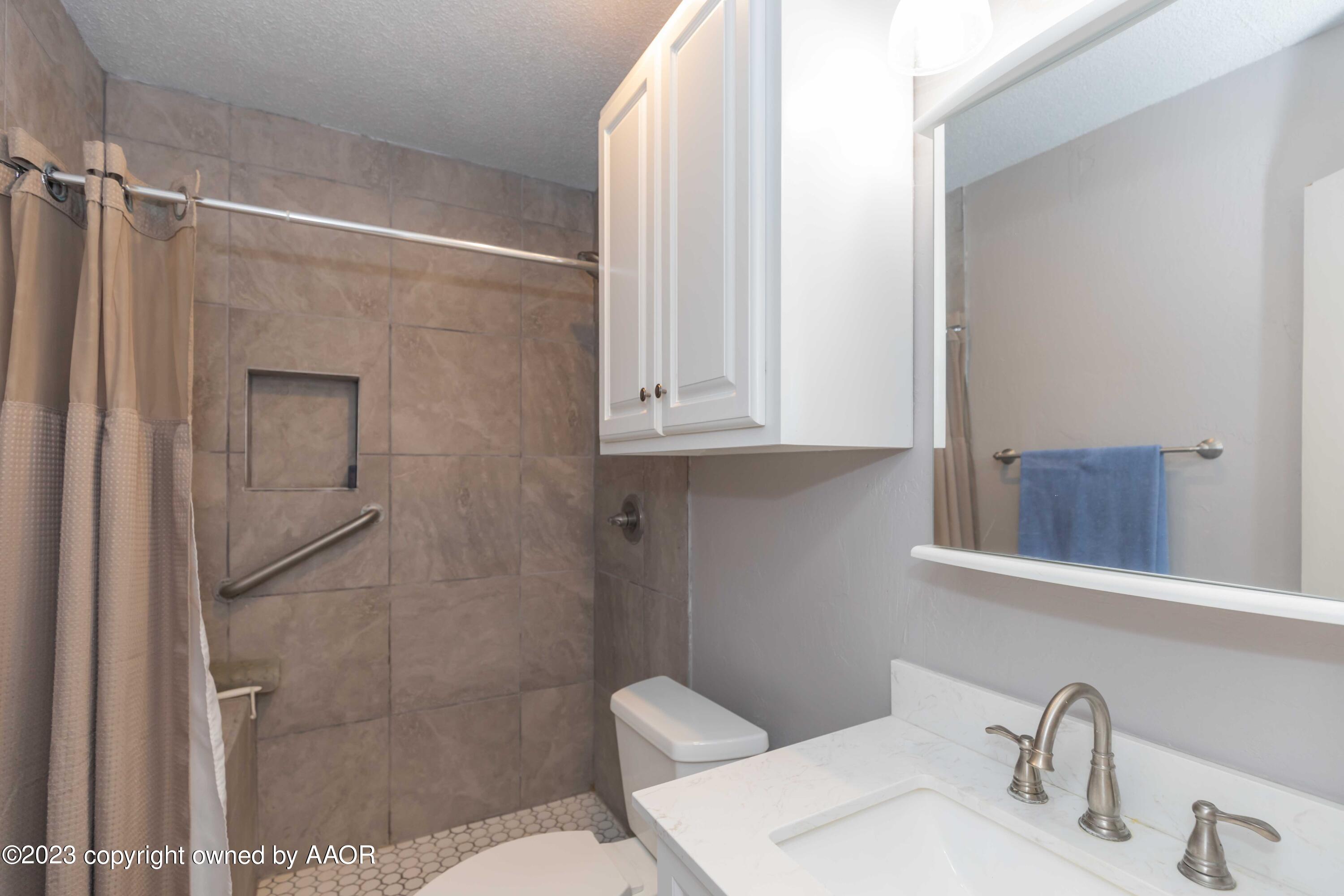 2920 South Nelson Street Amarillo, TX 79103 - Photo 27 of 47 a bathroom with a shower toilet and sink