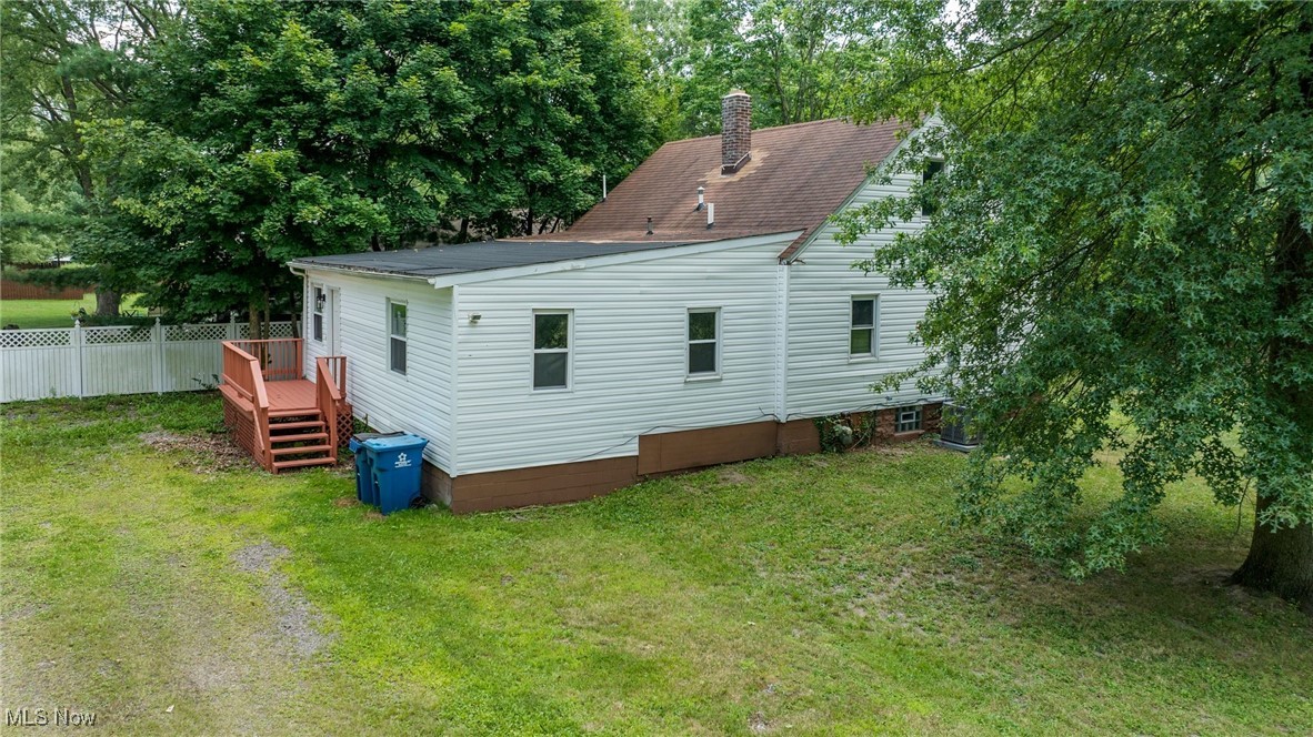 1424 Carson Salt Road Warren, OH 44481 - Photo 37 of 37 Rear view of house featuring a yard, a deck, a chimney, view of scattered trees, and roof with shingles