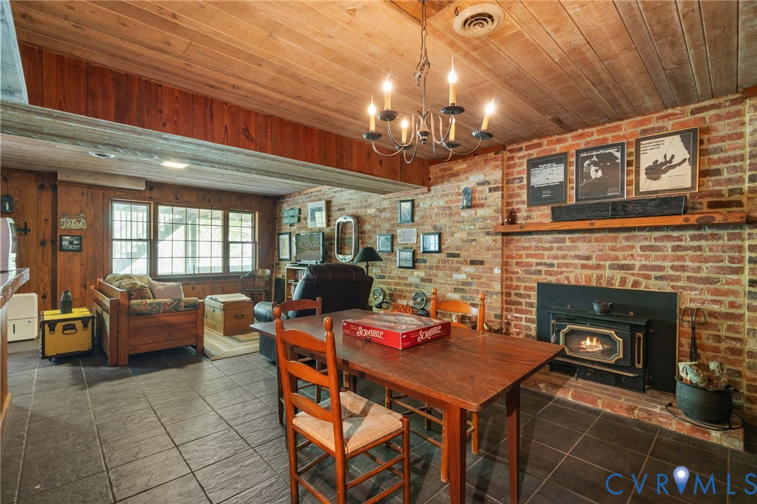 7381 McClellan Road Mechanicsville, VA 23111 - Photo 12 of 66 a living room with furniture a fireplace and a chandelier