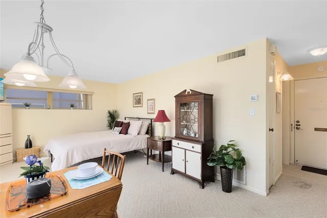 a living room with furniture and flowers