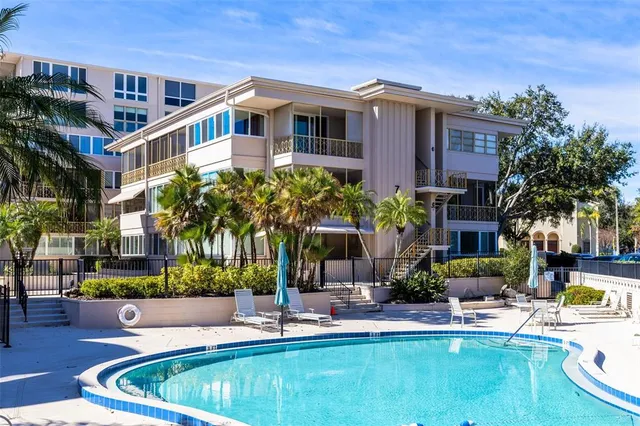 a front view of a house with swimming pool garden and outdoor seating