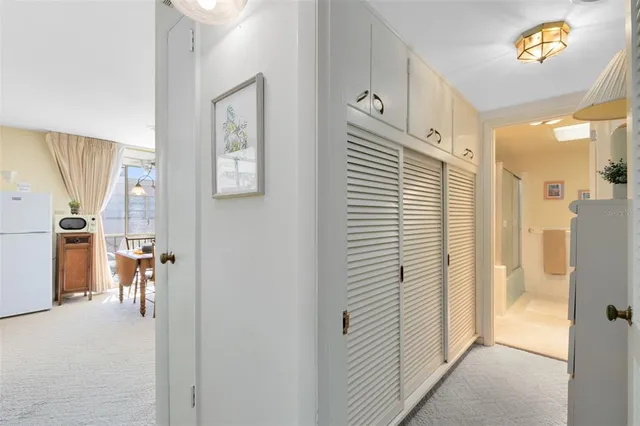 a view of a hallway with dining area and chandelier