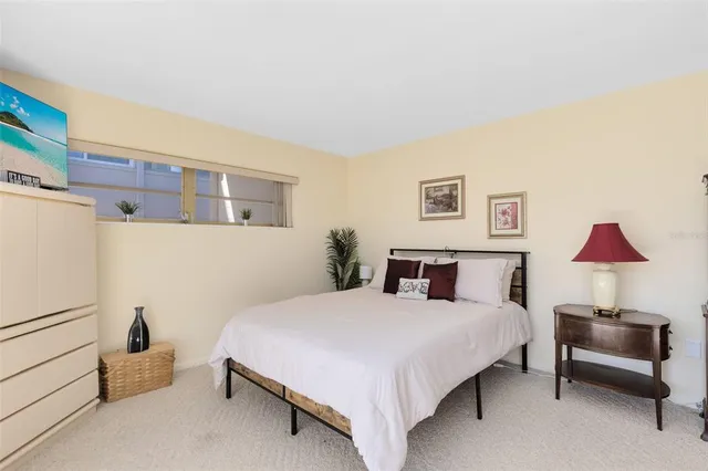 a bedroom with a bed and a lamp