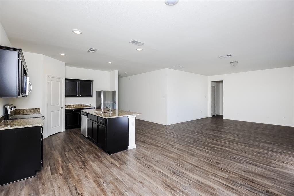 505 Canoe Way Crowley, TX 76036 - Photo 4 of 17 a view of kitchen with microwave oven stove and cabinets